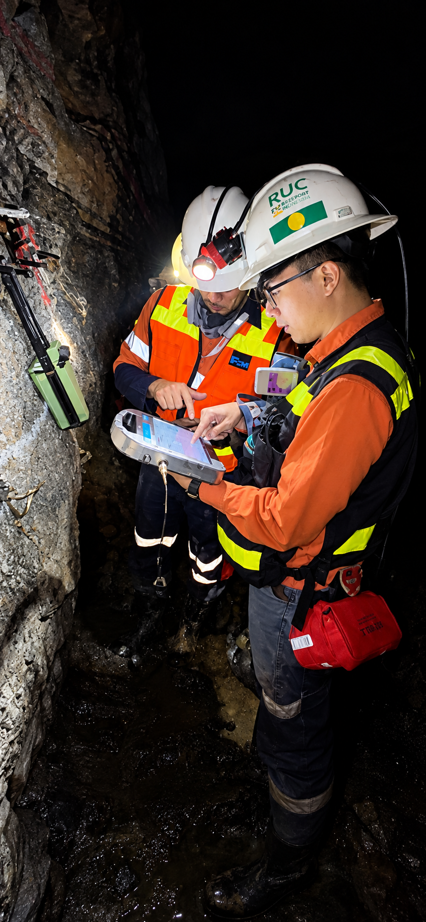Underground field activity: reviewing a handheld device with a colleague